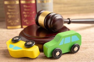 Hammer gavel judge with car vehicle accident, insurance coverage claim lawsuit court case.