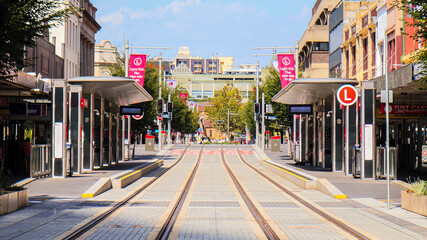 Landscape view of Sydney's light rail line and tram stop on Church Street on a quiet afternoon
