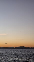 Serene sunset over the ocean creates a peaceful and calming atmosphere, perfect for travel inspiration or promoting relaxation and mindfulness retreats