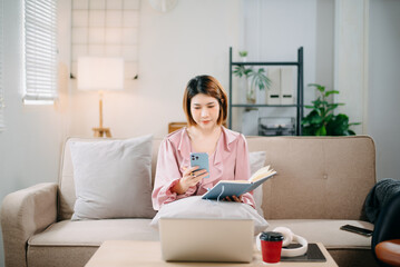 young asian woman working at home with laptop, freelancing concept