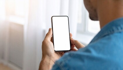 Man Holds Smartphone with Blank Screen for Mockup at Home Technology Concept.