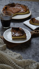cheese cake on a plate and black  coffee