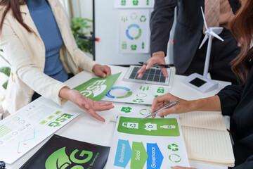 Business team analyzing ESG, environment, social, and governance reports, planning future green energy and eco friendly initiatives