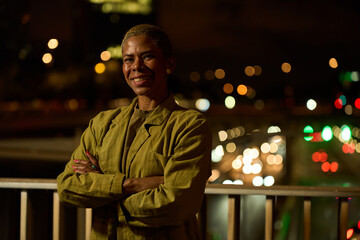 Smiling woman with short hair posing at night