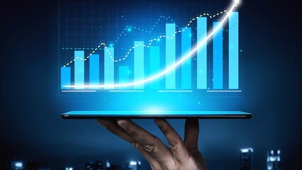 A hand holds a tablet displaying illuminated financial growth graphs over a city skyline, symbolizing business success, technology innovation, and future investments. Copula