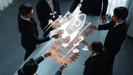 A diverse group of professionals collaborates in a modern workplace, engaging in strategic discussions while utilizing innovative tools and symbols for growth and success. Raster