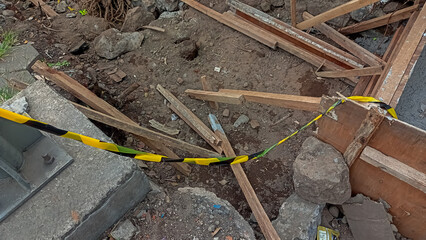 Barrier tape is prohibited from crossing the road construction project.