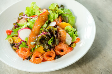 Delicious and healthy salmon salad served in a white bowl