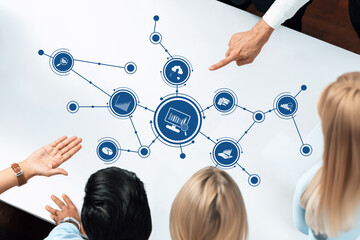 Diverse team engaging around a table displaying data analytics visuals, fostering productive discussions about business strategies and insights to drive innovation and growth. Amity