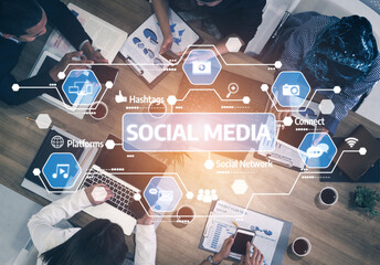 A dynamic top-down view of a diverse group of professionals engaged in social media strategy. Digital icons represent key concepts of networking and communication in a business setting. Tessel