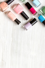 group of nail polish on wooden background top view