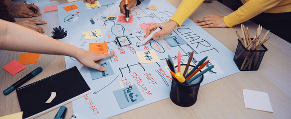 A diverse team engages in a creative brainstorming session, utilizing colorful sticky notes and...