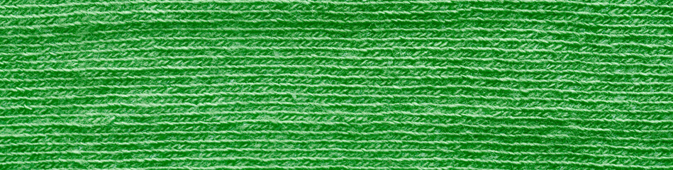 Macro of green synthetic fabric with microthread weave and neat horizontal lines; soft, warm, cozy texture ideal for high‑resolution backgrounds and web banners. Photo