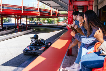 Fototapeta premium Friends cheering, experiencing excitement and competition at a go kart track, enjoying a fun day together
