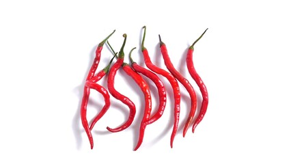 Top view of Red chili peppers or Cabai Merah Keriting isolated on white background with copy space. Perfect for design element, spicy food concept or any commercial usage.