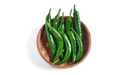 Top view of Green hot chili peppers on bamboo bowl. Isolated on white background with copy space. Clipping path. Perfect for design element, spicy food concept or any commercial usages.