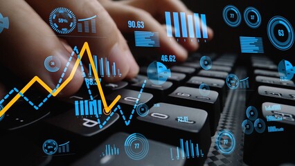 A close-up of hands typing on a keyboard, with vibrant data visualization elements showcasing graphs and analytics, indicating a modern and dynamic office setting. Xenic