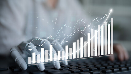 Focused on business growth, this image features a hand on a keyboard with overlaid digital graphs, illustrating data analysis and strategic financial planning. Impute