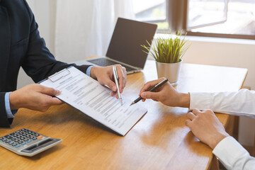 Asian landlord, realtor man pointing on paper for sign signature contract with tenant rental or...