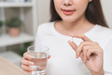 Dietary supplement, healthy diet positive asian young woman hand holding pill capsule, take vitamin...