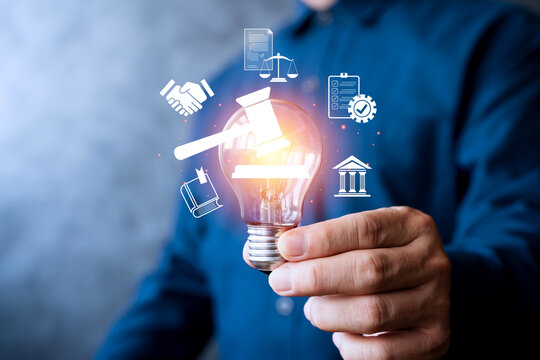 Innovation and law concept with glowing light bulb and legal icons representing justice and regulation