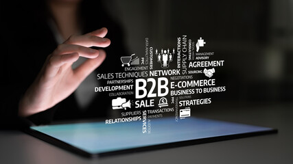 A business professional engages with digital B2B icons on a tablet in a modern office, illustrating...