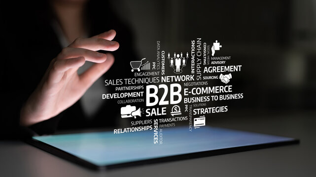 A business professional engages with digital B2B icons on a tablet in a modern office, illustrating concepts like sales, networking, and agreements for business growth. Tessel