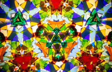 Natural kaleidoscope pattern captured with a camera, featuring vibrant stained glass colors and...