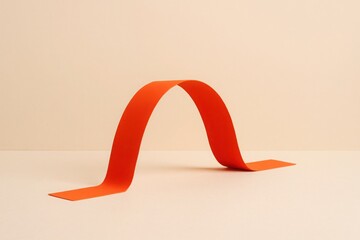 Flexible orange ribbon bridge arching over soft beige background symbol of resilience adaptation crisis solution flexibility minimal business concept with space for text