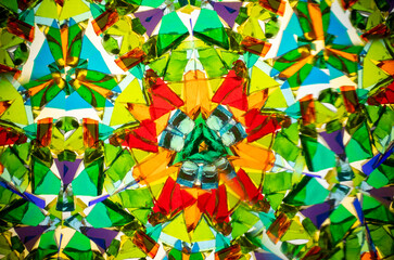 Natural kaleidoscope pattern captured with a camera, featuring vibrant stained glass colors and...