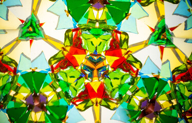 Natural kaleidoscope pattern captured with a camera, featuring vibrant stained glass colors and...