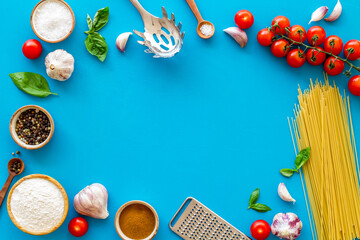 Food ingredients for cooking Italian pasta with tomatoes and basil leaves, top view