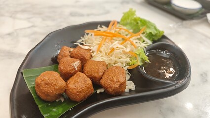 Fried shrimp ball served with sweet plum sauce.