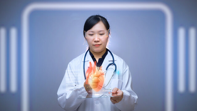 Female Doctor Analyzing Holographic Heart Model on Transparent Digital Tablet, Symbolizing Future Cardiology and Medical Augmented Reality Technology