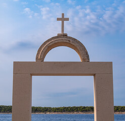 Stone Arch with Cross Overlooking the Sea