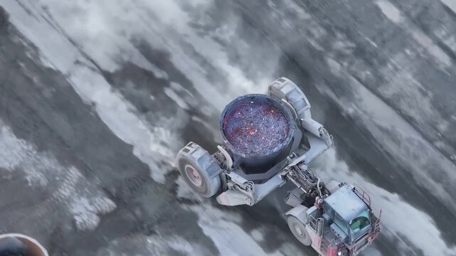 Aerial overhead view of molten slag ladle transport at industrial site