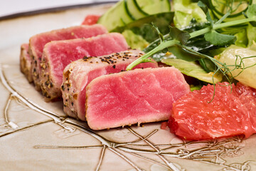Freshly seared tuna slices served with a vibrant salad