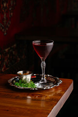 a glass of wine in a restaurant on a dark background