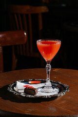 red cocktail in a restaurant on a wooden background