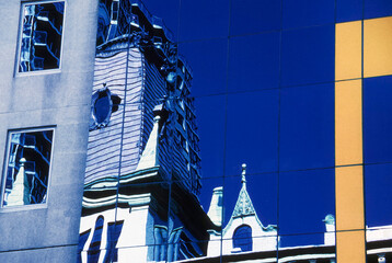 Buildings reflected in the windows of a modern office block