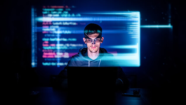 Man is sitting at a desk and working on a computer