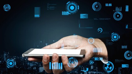 A hand presents a smartphone featuring an advanced digital interface with data visualizations, set against a modern urban backdrop, symbolizing technology and innovation. Xenic