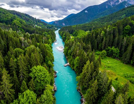 Aerial view of a turquoise river winding through a lush green valley (1) - Powered by Adobe