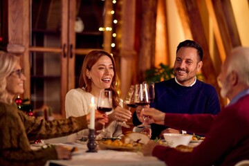 Friends and Family Toast Together at a Festive New Year Dinner Celebration