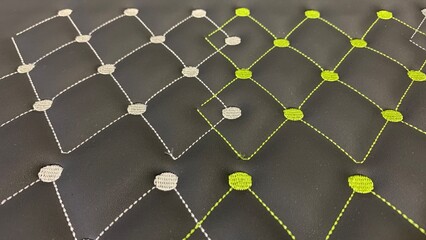 Obraz premium Modern quilted pattern with lime green and silver stitching on rich black fabric creates trendy luxury