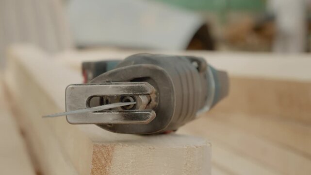 The reciprocating saw is positioned on a construction site, ready for various cutting jobs. Its powerful design makes it essential for construction work.
