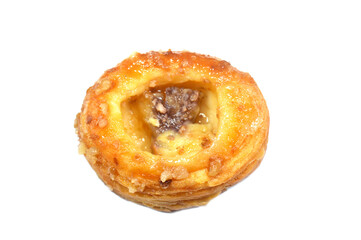A Danish pastry, a sweet, multilayered, flaky pastry made from a laminated, yeast-leavened dough with a high butter content, soaked with sweet honey syrup, filled with cinnamon, raisin and pineapple