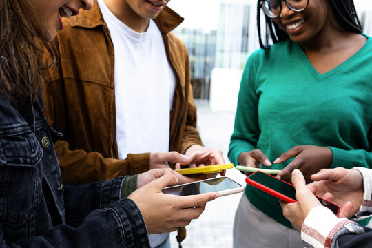 Group of young students using smartphones outdoors - Powered by Adobe