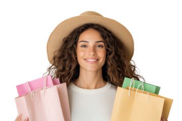 Happy woman with curly hair wearing a hat, holding colorful shopping bags against a white background.