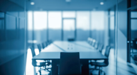 Blurry modern conference room seen through glass wall with blue tone for corporate business meeting or confidential negotiation presentation background